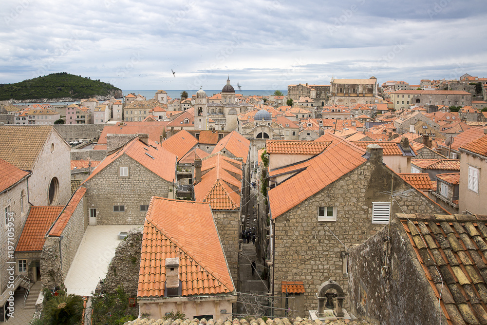 View over the orange rooftops of old town Dubrovnik from the ancient city wall with cloudy weather, Croatia