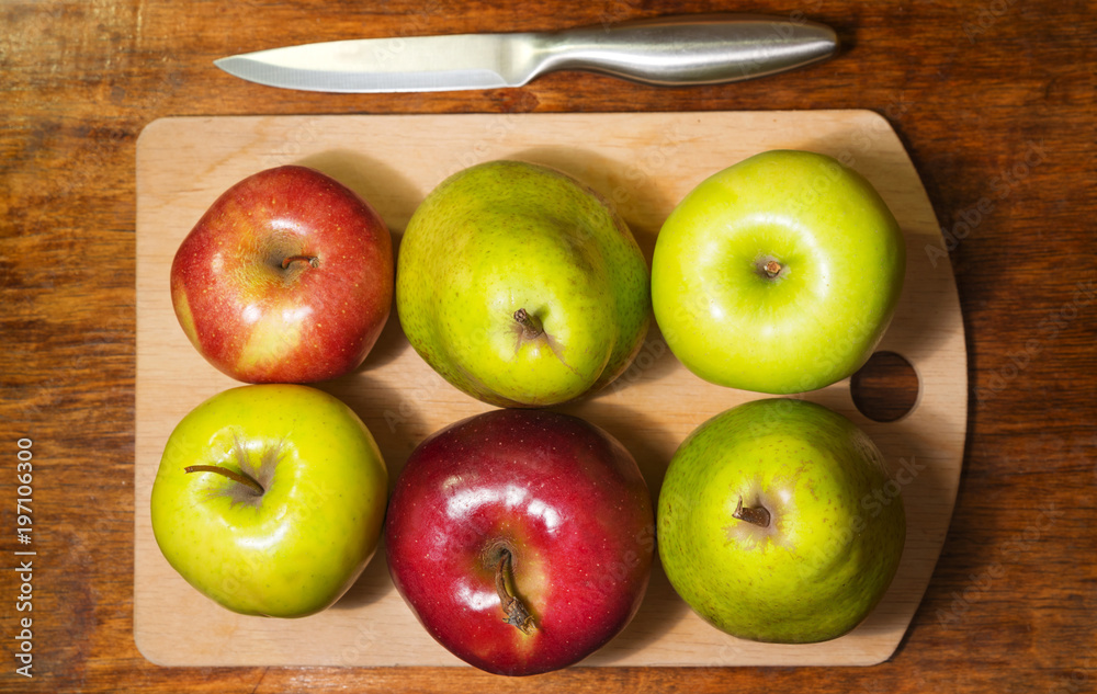 A top view of the six green and red apples on the cutting board A top view of the six green and red apples on the cutting board