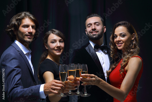 Cheerful people celebrating a sucess with Champagne
