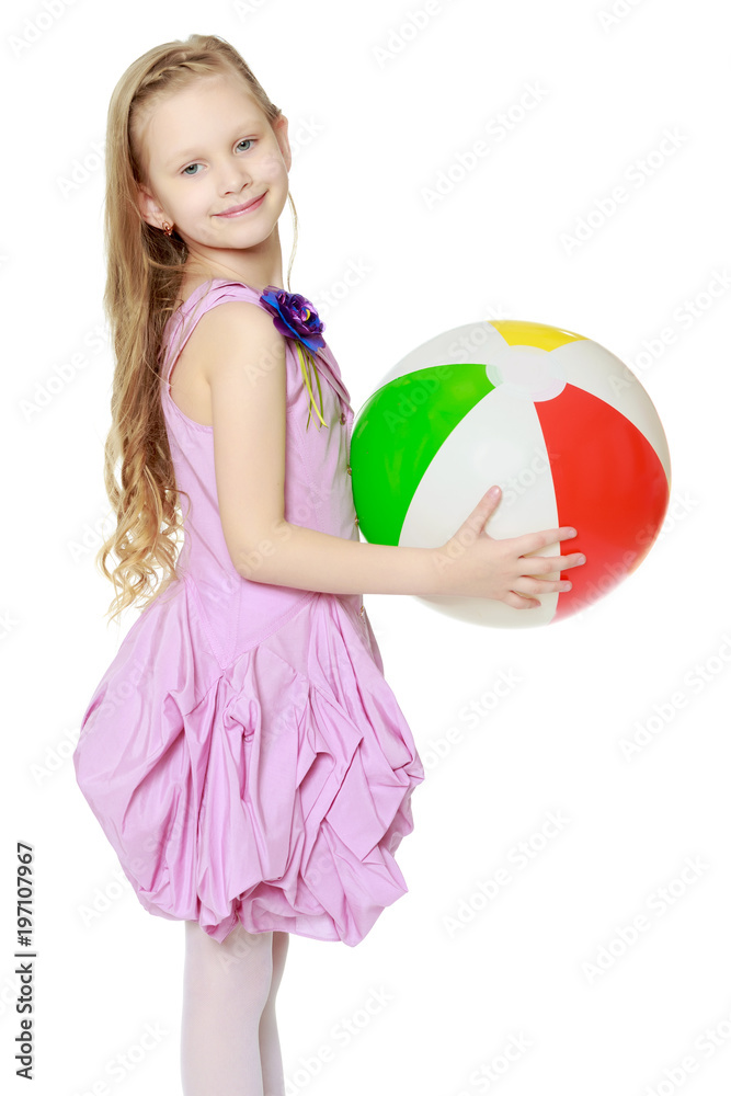 Beautiful little girl with a large multi-colored inflatable ball Beautiful little girl with a large multi-colored inflatable ball