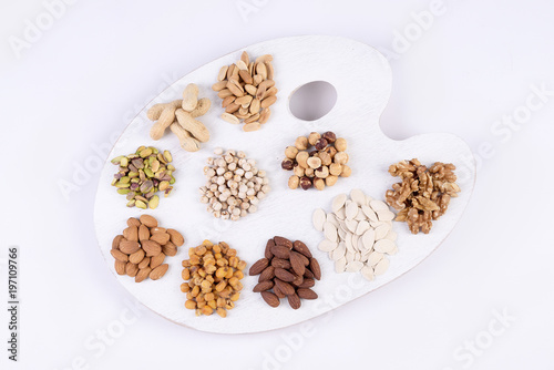 Painter's table with dried fruit on white background