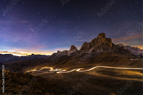 Car travels through mountains at night © NIXON Photography