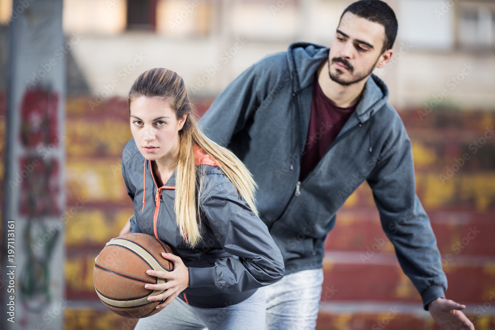 Young couple playing basketball Young couple playing basketball