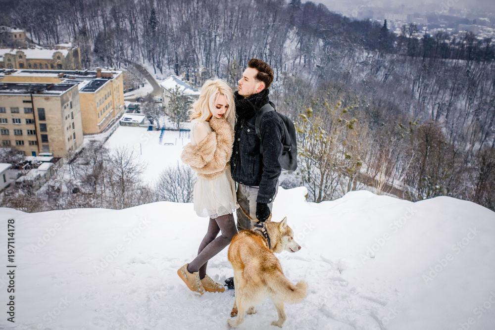 Entrancing couple is standing on a high snow-covered mountain