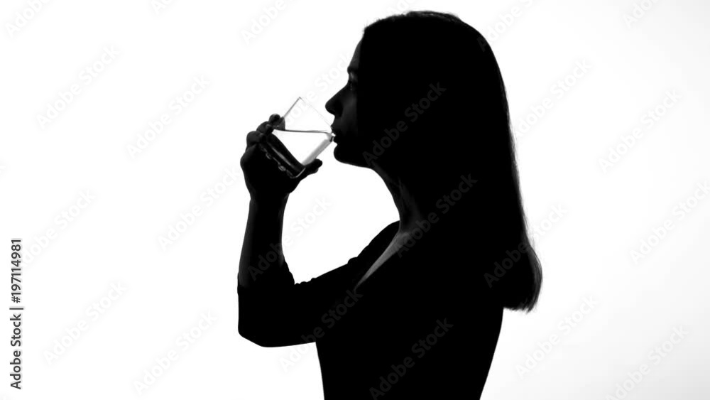 Female silhouette drinking glass of water, restoring ph balance, weight loss Female silhouette drinking glass of water, restoring ph balance, weight loss
