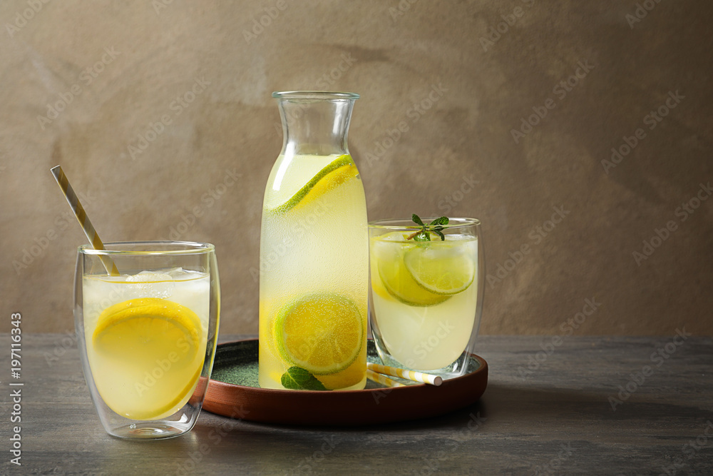Jar with fresh lemonade and ingredients on table Jar with fresh lemonade and ingredients on table