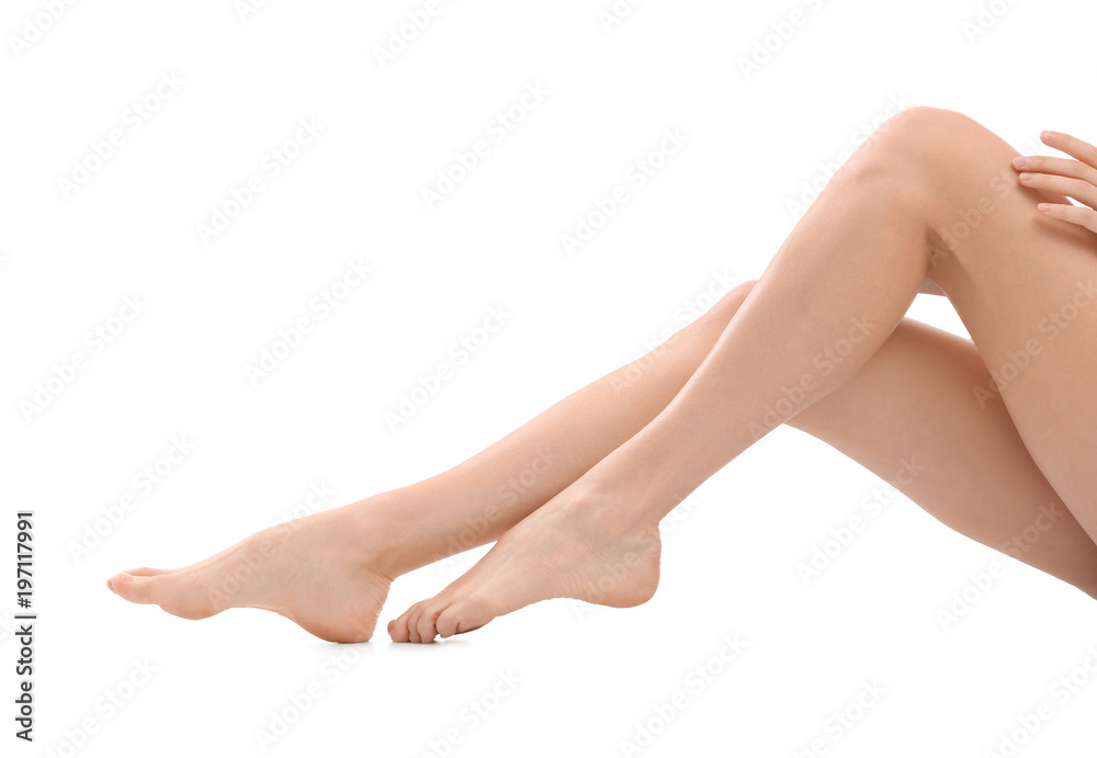 Young woman with silky skin on white background, closeup of legs Young woman with silky skin on white background, closeup of legs