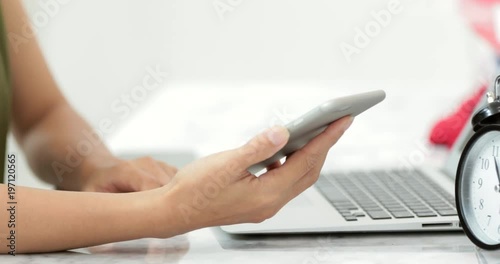 Young asian woman waiting for laptop computer loading data.