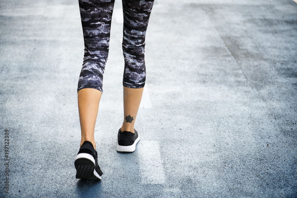 Woman jogging down the road