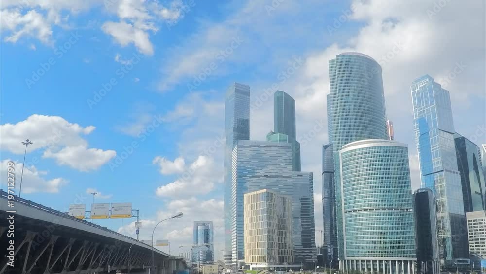 modern glass skyscrapers and bridge at summer timelapse modern glass skyscrapers and bridge at summer timelapse