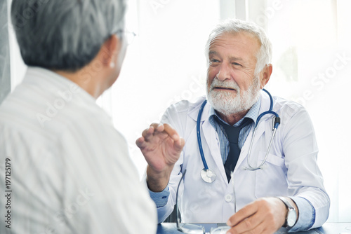 Senior male Doctor talking with male patient.