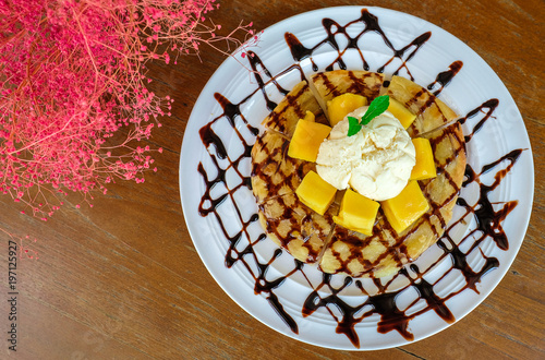 roti and ice cream with mango and chocolate syrup photo