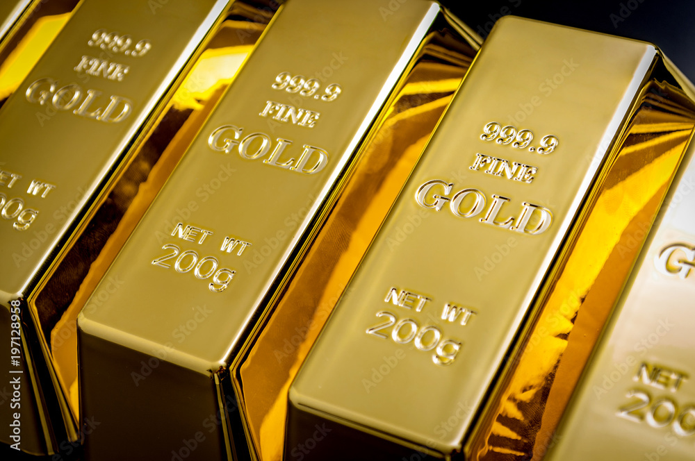 National reserve of gold, financial stability and commodity trading concept with many pure solid gold bars in a raw on black background with copy space National reserve of gold, financial stability and commodity trading concept with many pure solid gold bars in a raw on black background with copy space