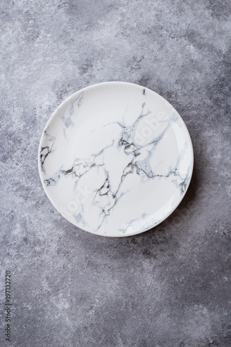 Empty ceramic marble plate on gray stone concrete table background. Copy space. Menu Recipe Concept