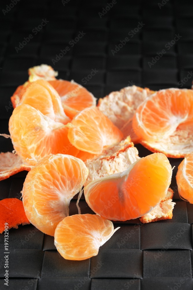 Orange peel mandarines on a dark background on a wooden table. Tropical fruits. Closeup for concept design. Orange peel mandarines on a dark background on a wooden table. Tropical fruits. Closeup for concept design.