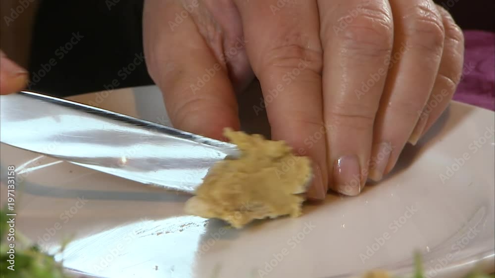 Close up shot of hands slicing, spreading and picking up a pita bread to eat. Close up shot of hands slicing, spreading and picking up a pita bread to eat.