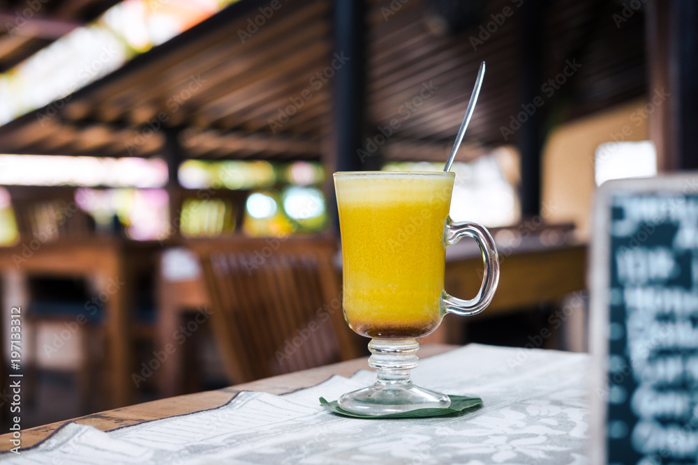 Turmeric golden latte on coconut milk at the restaurant. Vegan raw food concept. Drink photography Turmeric golden latte on coconut milk at the restaurant. Vegan raw food concept. Drink photography