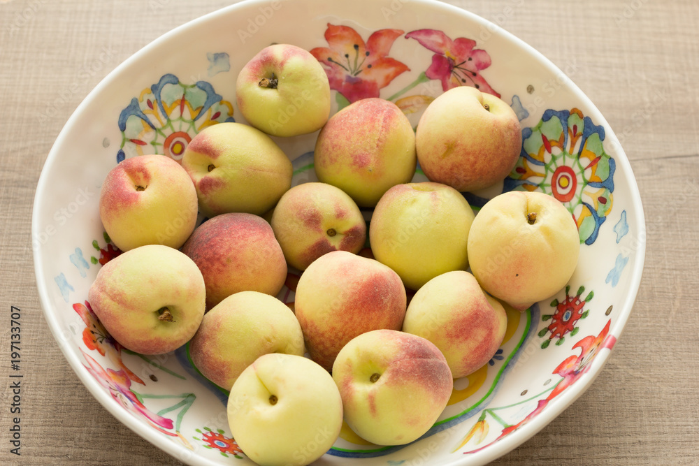Peaches and colorful bowl. Fruits on wooden table. Peaches and colorful bowl. Fruits on wooden table.