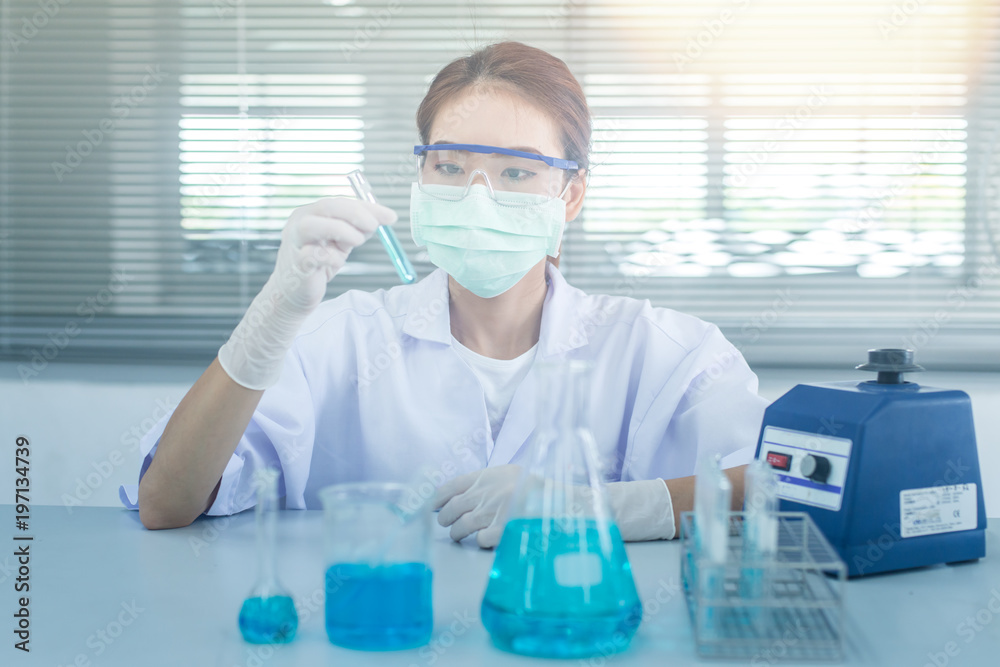 Professional distinguished Science specialist at work.Young Asian scientist with test tube making research in clinical laboratory.Innovative technologies in science and medicine Professional distinguished Science specialist at work.Young Asian scientist with test tube making research in clinical laboratory.Innovative technologies in science and medicine