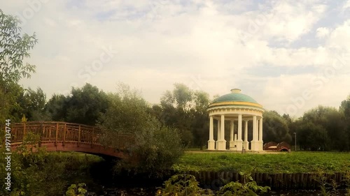 wooden bridge and rotunda in the city park timelapse