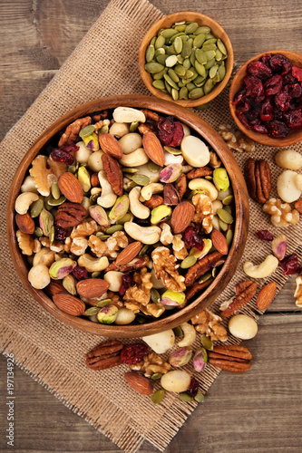 Mixed nuts in wooden bowl with linen mat