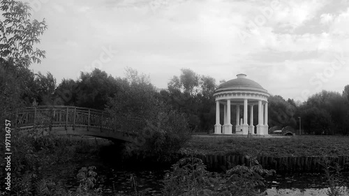 bridge and rotunda in the park black and white timelapse