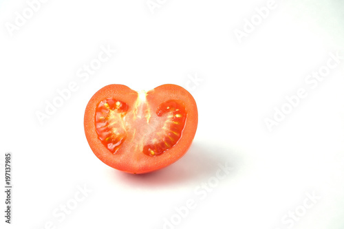 Isolated tomato. Pieces of cut fresh tomatoes over white background.