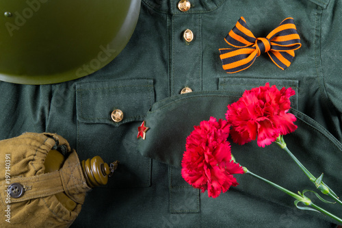 a holiday on May 9 with a St. George ribbon and two carnations, on the background of military clothes