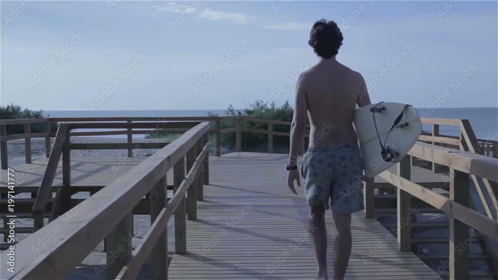 Surfer walking with surf board going towards the ocean. Surfer walking with surf board going towards the ocean.