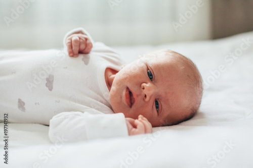 Newborn baby looking at camera