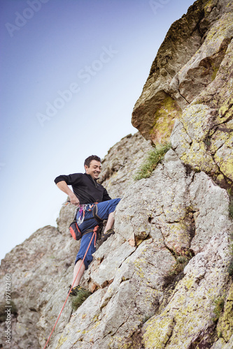 man climbing a rock wall © charlymorlock