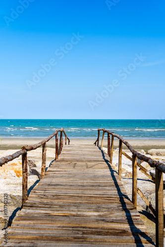 Wooden bridge walkway to the sea beach