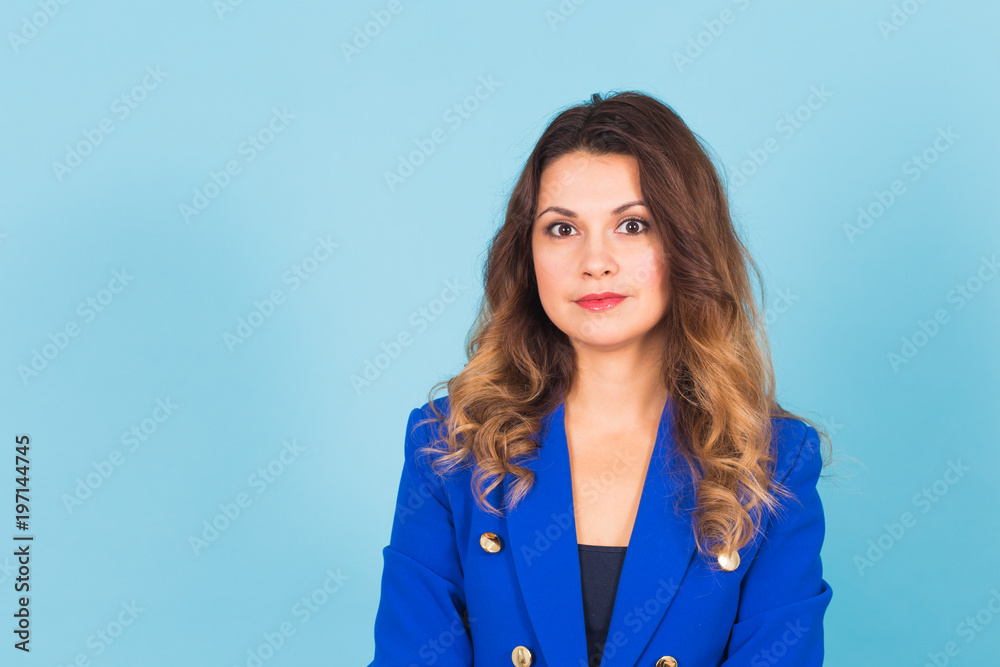 Smiling young business woman portrait on blue background. Smiling young business woman portrait on blue background.
