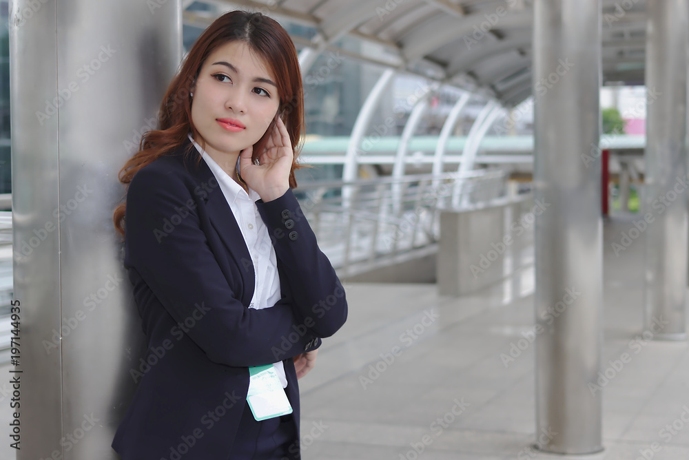 Portrait of beauty young Asian businesswoman in suit standing and looking at far away. Thinking and thoughtful business concept. Portrait of beauty young Asian businesswoman in suit standing and looking at far away. Thinking and thoughtful business concept.