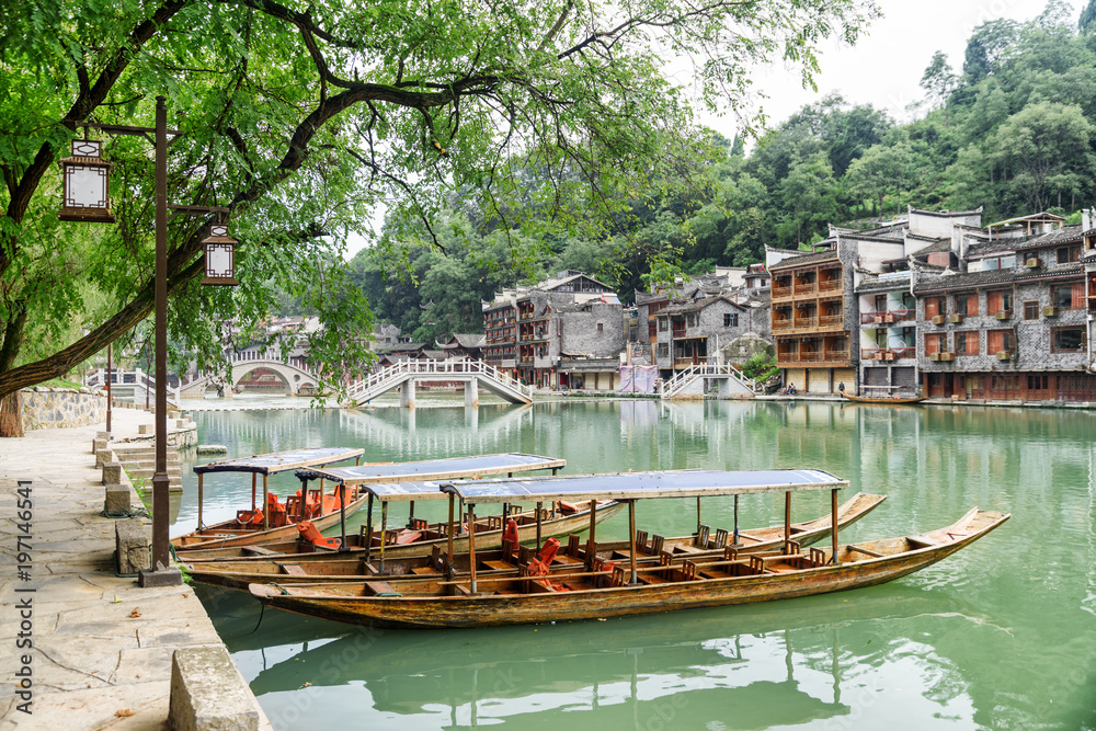 Parked wooden tourist boats on the Tuojiang River, Fenghuang
