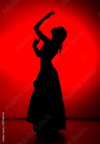 silhouette of spanish girl flamenco dancer on a red background