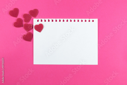 Valentine's day love letter with notebook on pink paper background with copy space. © Thinapob