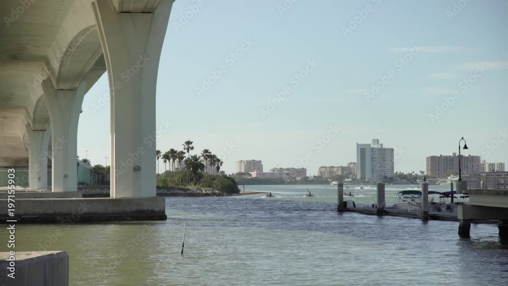 Pillars of a bridge and boats floating in the water Pillars of a bridge and boats floating in the water