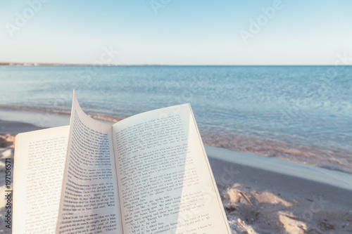 Fototapeta Naklejka Na Ścianę i Meble -  Reading book near the sea