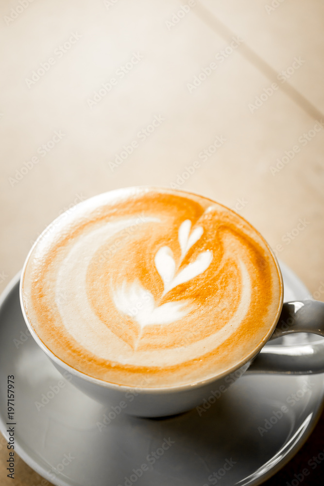cup of coffee with heart pattern in a white cup on wooden background cup of coffee with heart pattern in a white cup on wooden background