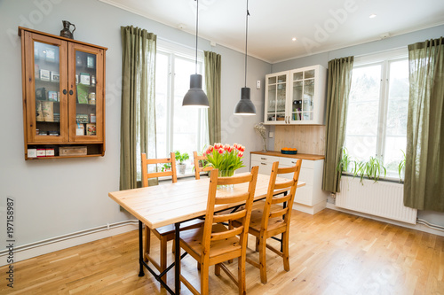 kitchen table in cozy kitchen with green curtains