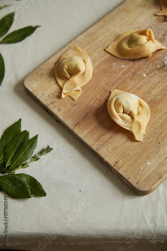 Overhead view of traditional italian handmade ravioli on cutting board