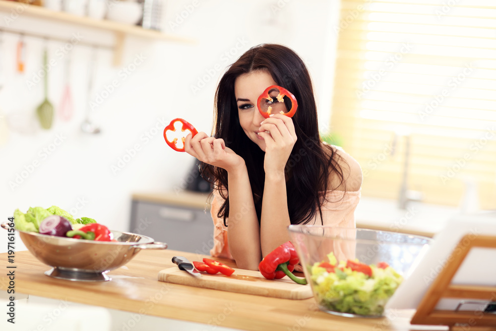 Happy woman preparing salad in modern kitchen Happy woman preparing salad in modern kitchen
