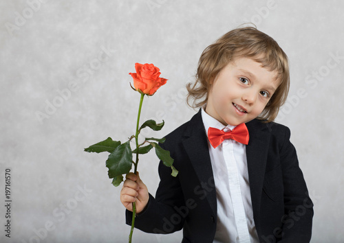 Small boy of four years with a rose. photo