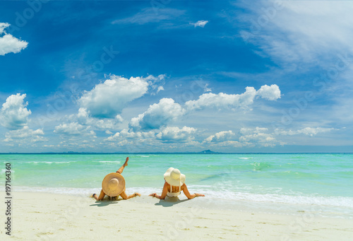 Fototapeta Naklejka Na Ścianę i Meble -  Two women relaxing at the White sand beach