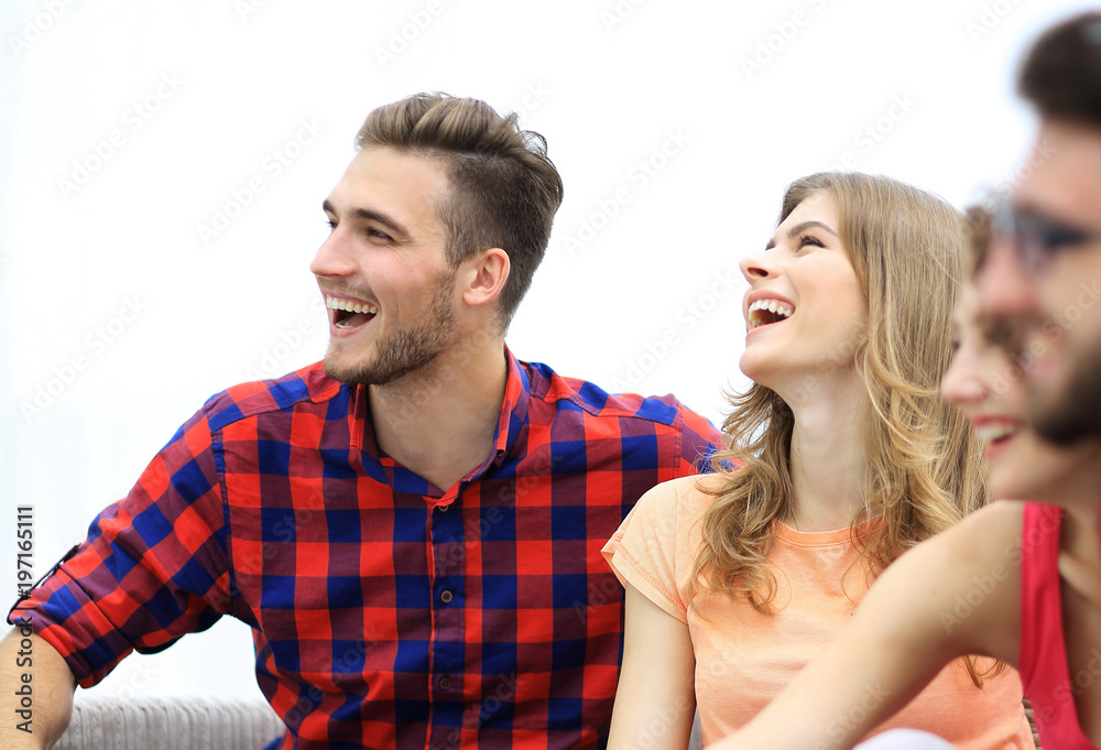 group of cheerful friends sitting on the couch group of cheerful friends sitting on the couch