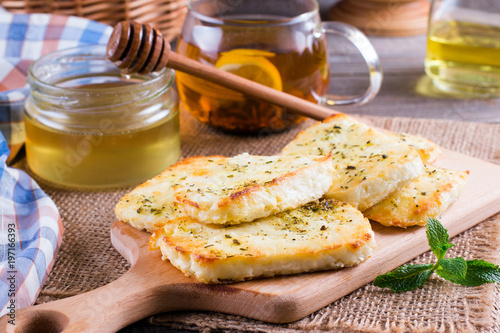 Grilled haloumi cheese with herbs on a cutting board