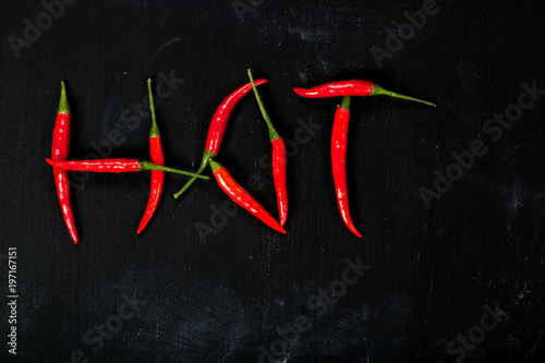 Fresh hot chili pepper on a wooden surface.