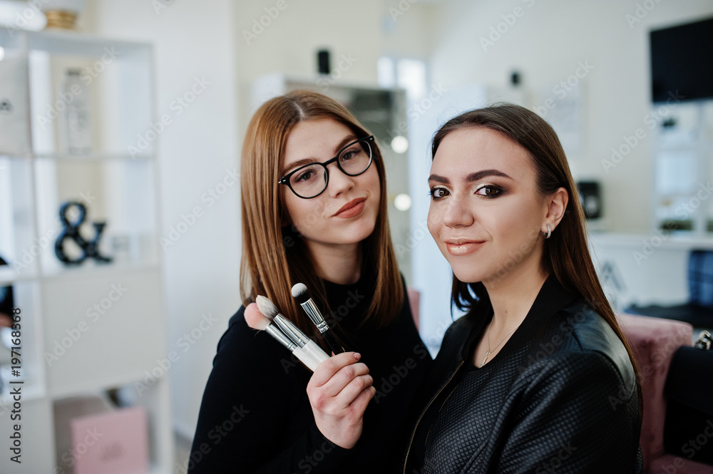 Make up artist work in her beauty visage studio salon. Woman applying by professional make up master. Beauty club concept. Make up artist work in her beauty visage studio salon. Woman applying by professional make up master. Beauty club concept.