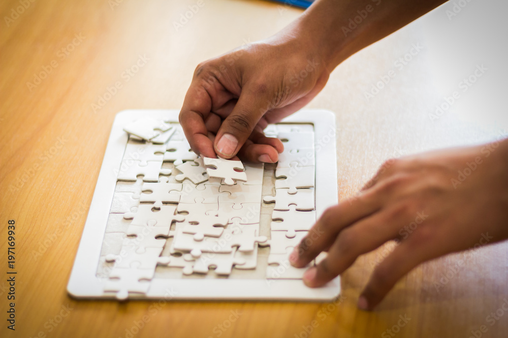 Man hands connecting couple puzzle piece Man hands connecting couple puzzle piece